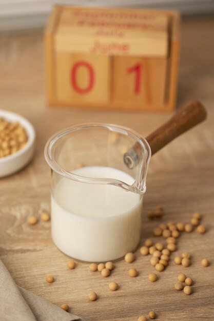 High angle milk cup and chickpeas on table