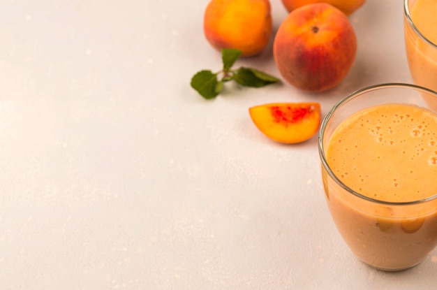 High angle of milkshake glass with peaches and copy space