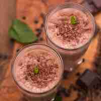 Free photo high angle of milkshake glasses with chocolate and mint