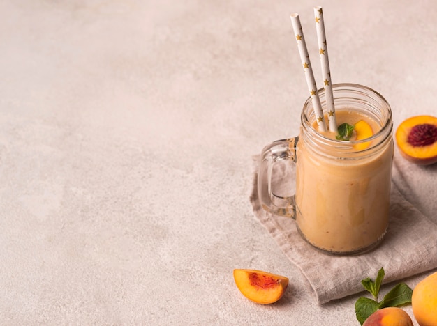 Free photo high angle of milkshake with peaches and mint