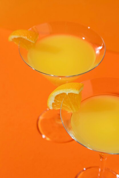 Free photo high angle mimosa cocktails with orange slices