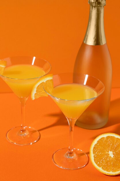 High angle mimosa glasses with orange slices