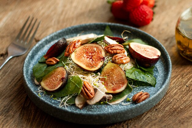 High angle mix of nuts and figs on plate with strawberries