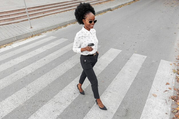 High angle modern woman crossing  crosswalk