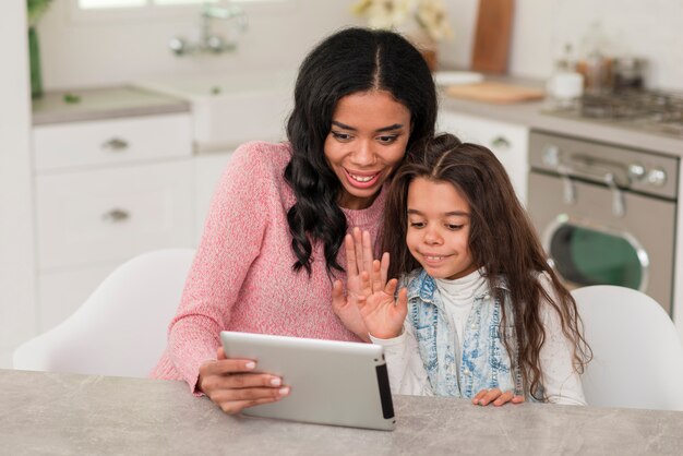 High angle mom and daughter using tablet