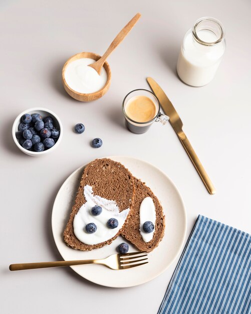 High angle of morning toast with blueberries and milk