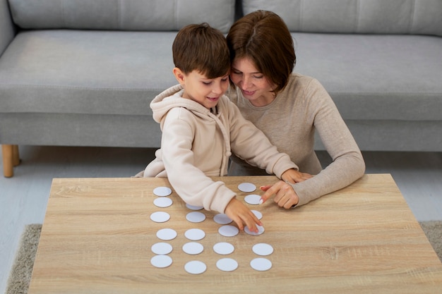 Free photo high angle mother and boy playing game