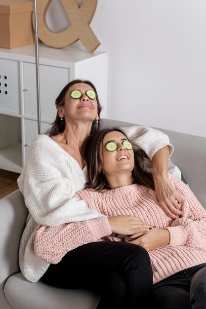 High angle mother and daughter face care