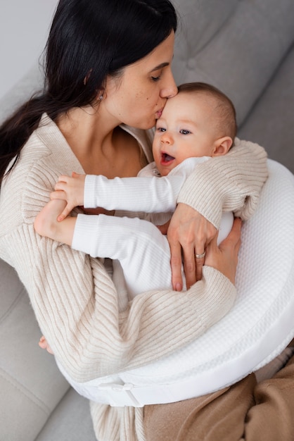 High angle mother holding newborn baby