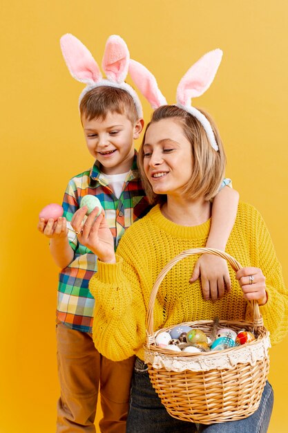 High angle mother and son looking at painted eggs