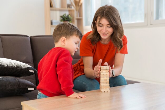 High angle mother and son playing janga game