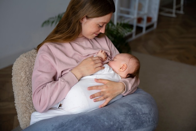 Free photo high angle mother with cute newborn