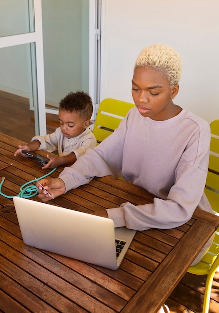 High angle mother working from home