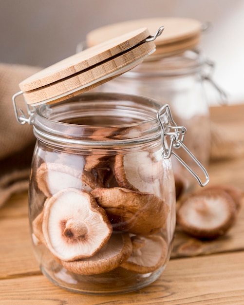 Free photo high angle of mushrooms in jars