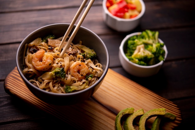 High angle of noodles in bowl with shrimp