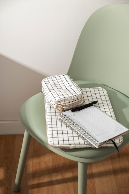 Free photo high angle notebook on green chair