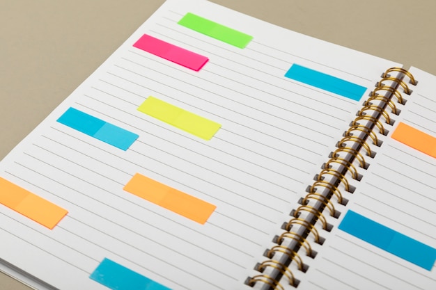 High angle notebook with colorful post its