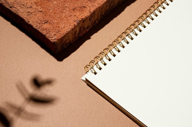 High angle of notebook with leaves shadow