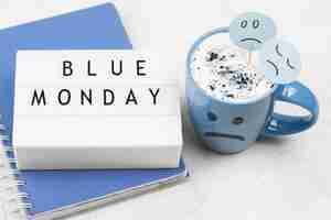 Free photo high angle of notebook with sad mug for blue monday