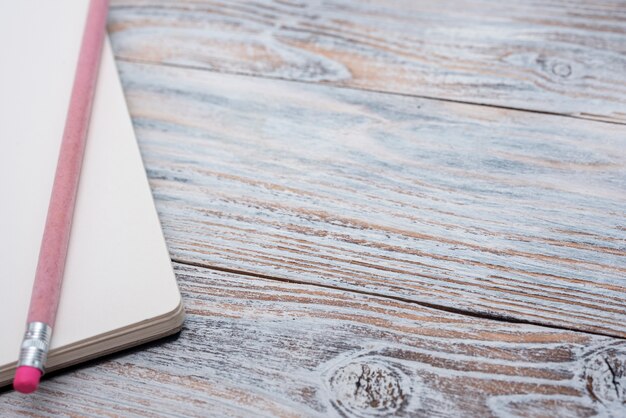 High angle of notebook on wooden table