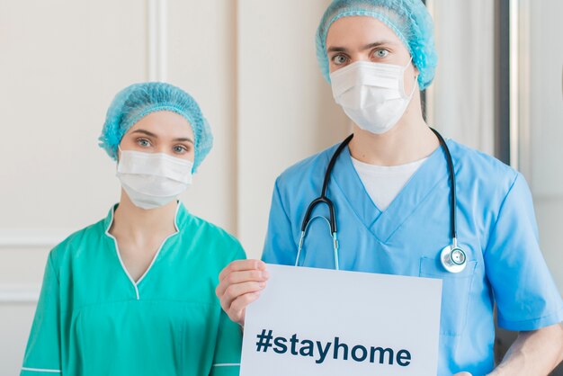 high angle nurses with stay home message