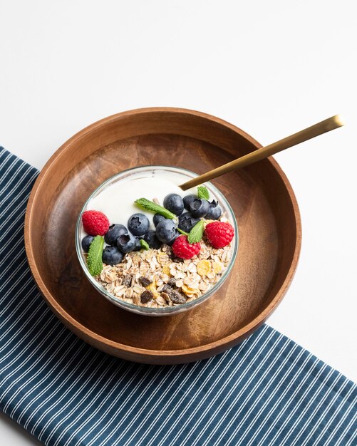 High angle of oatmeal bowl with raspberries and blueberries