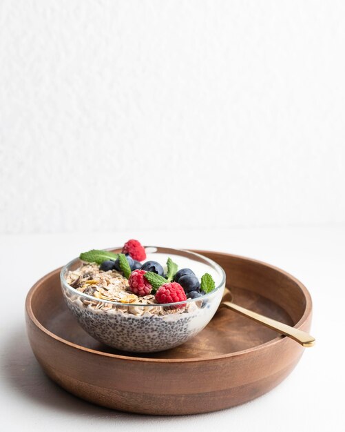 High angle of oatmeal bowl with raspberries and copy space