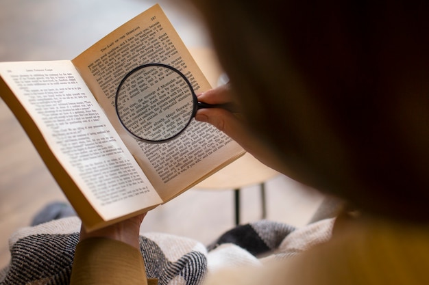 High angle old woman reading at home