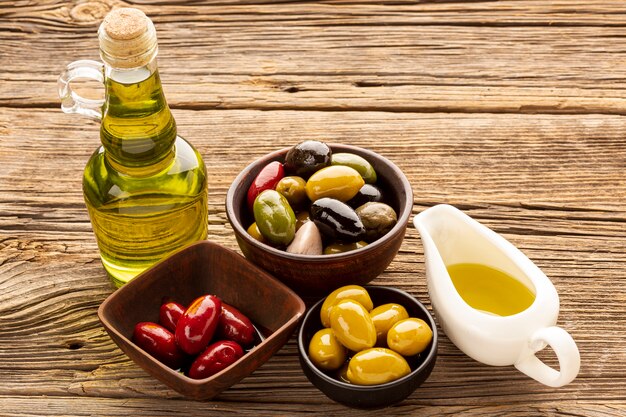 High angle olive bowls bread slices and oil