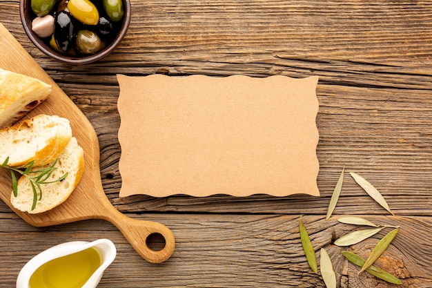 High angle olives mix bread and oil saucer with cardboard mock-up