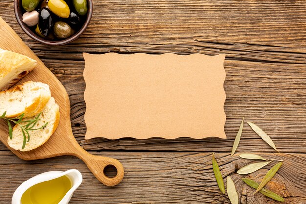 High angle olives mix bread and oil saucer with cardboard mock-up