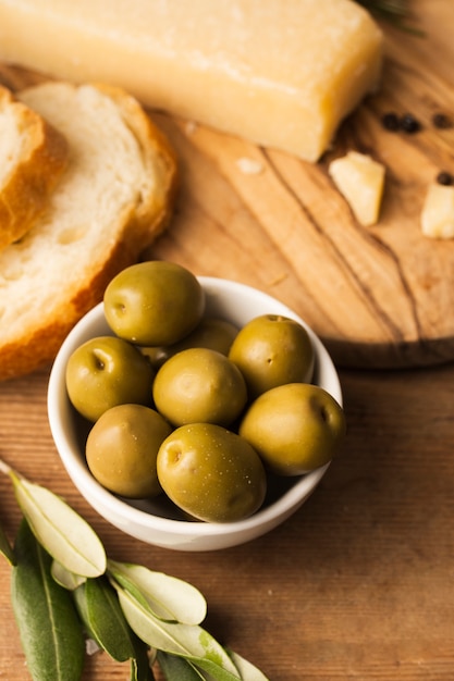 High angle olives parmesan and bread