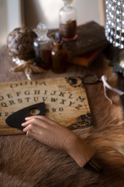 High angle ouija board and fake hand