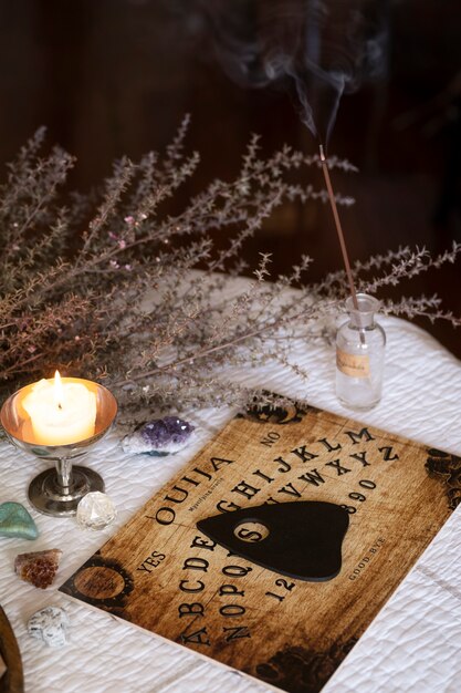 High angle ouija board and lit candle