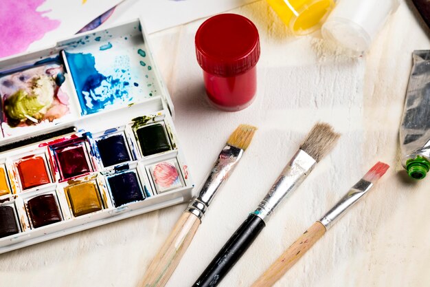 high angle of paint brushes and palette