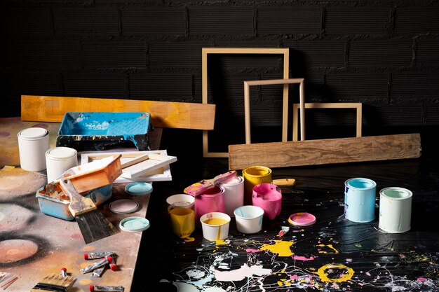 High angle of painting studio with cans and frames