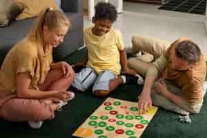 Free photo high angle parents and kid playing game