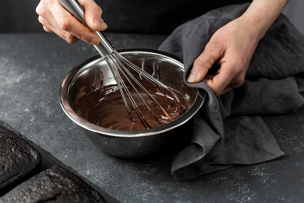 High angle of pastry chef preparing chocolate cake