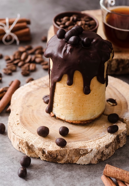 High angle of pastry with chocolate topping and coffee beans