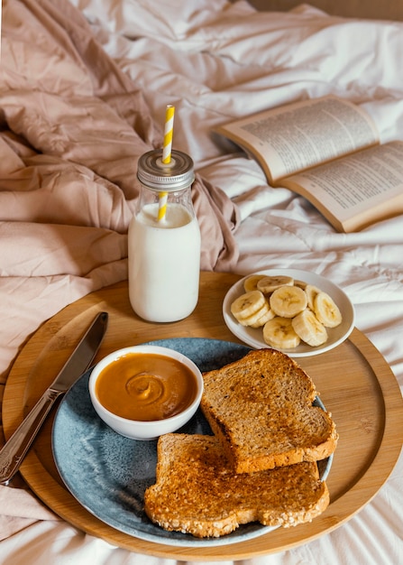 High angle peanut butter, milk and bread