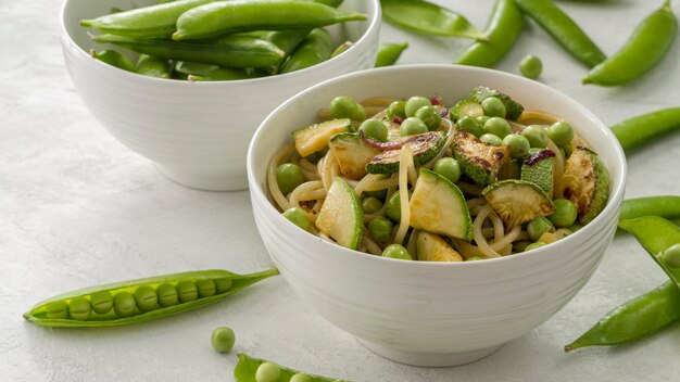 High angle peas with spaghetti and vegetables in bowl