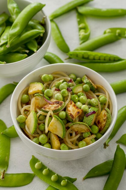 High angle peas with spaghetti and vegetables