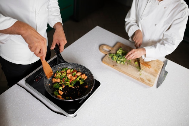 Free photo high angle people cooking together