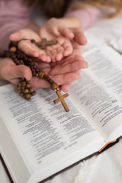 High angle people holding rosaries