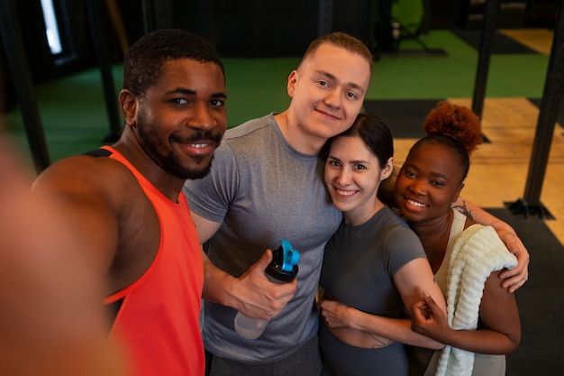 Free photo high angle people taking selfie at gym