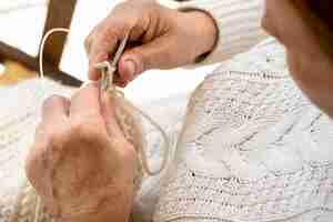 Free photo high angle of person crocheting with yarn