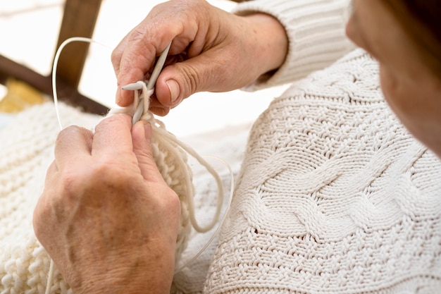 High angle of person crocheting with yarn