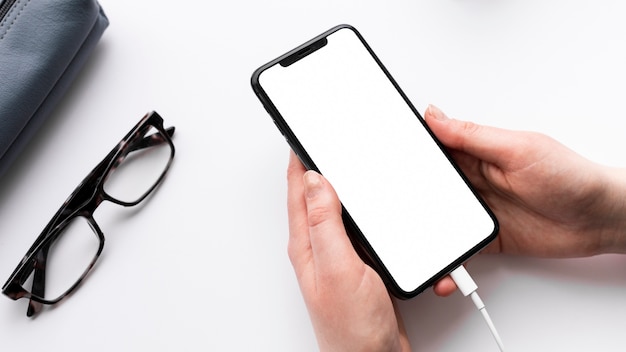 High angle person holding an empty display phone