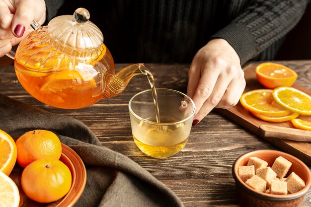 High angle of person pouring tea concept