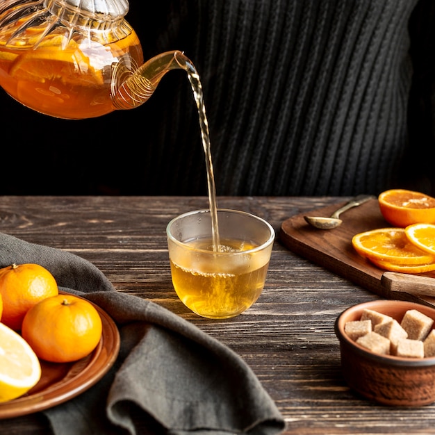 High angle of person pouring tea concept